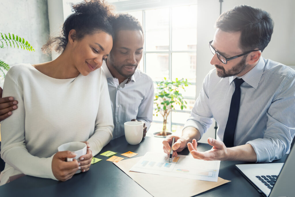 How Texas Community Property Laws Impact Estate Planning for Married Couples 1 Married couple reviewing estate planning documents with an attorney, smiling with reassurance.