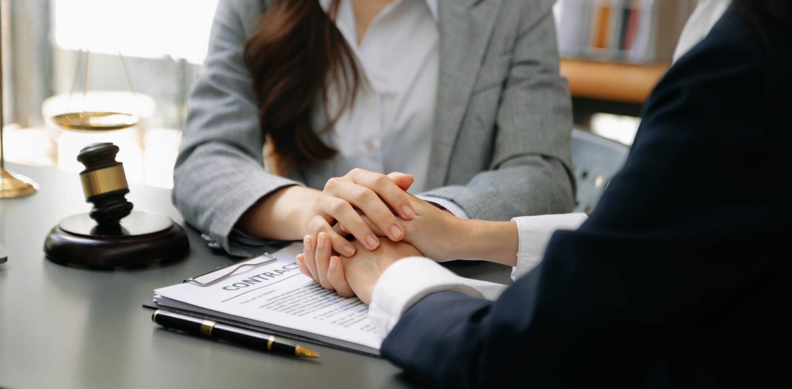 Business people compassionately holding hands and discussing con